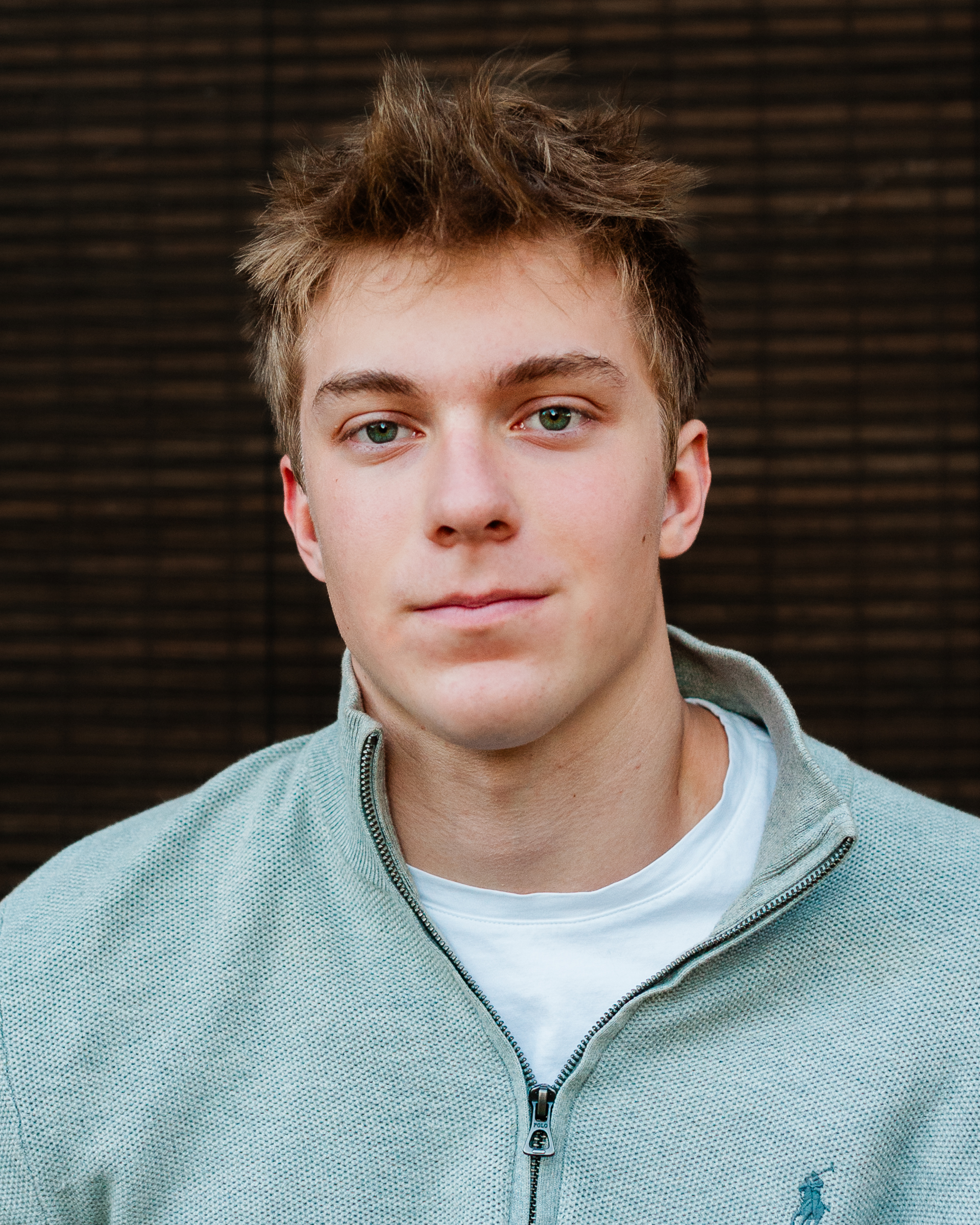 Jack Nielen close-up headshot in a grey knit sweater